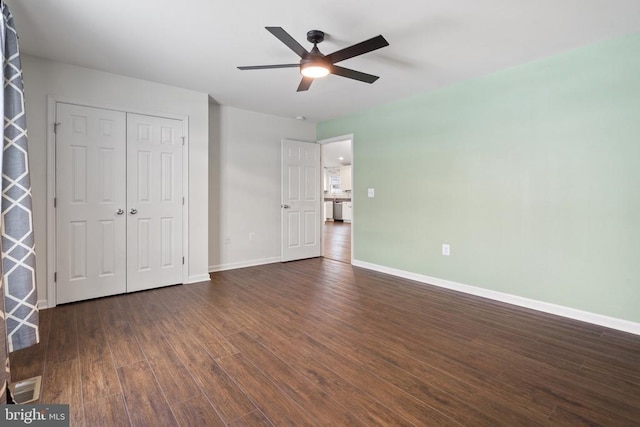 unfurnished bedroom with a closet, ceiling fan, and dark hardwood / wood-style floors