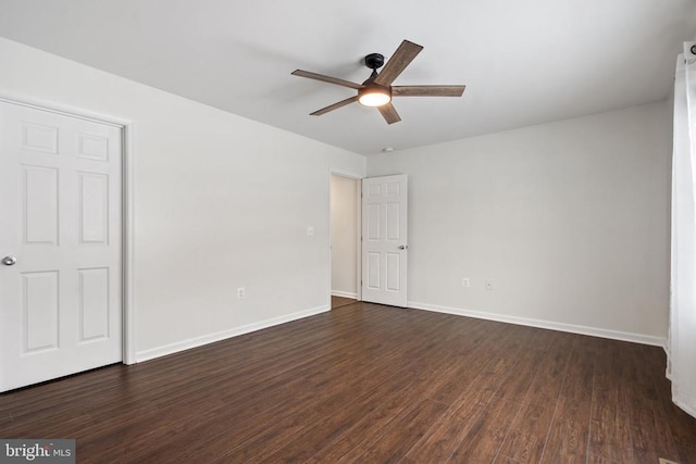 unfurnished room featuring ceiling fan and dark wood-type flooring