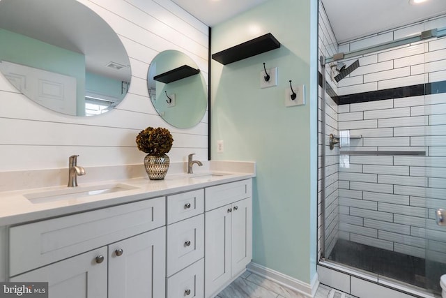 bathroom featuring wood walls, vanity, and walk in shower