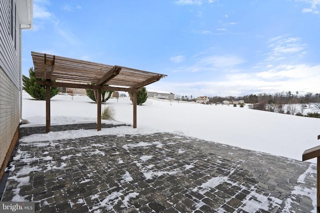 yard covered in snow featuring a pergola