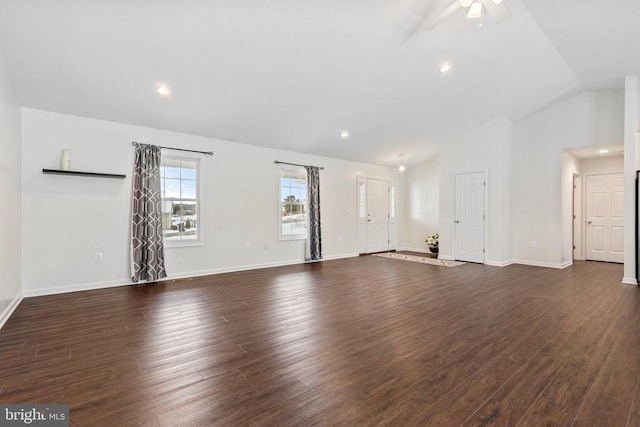 unfurnished living room with dark hardwood / wood-style flooring, vaulted ceiling, and ceiling fan