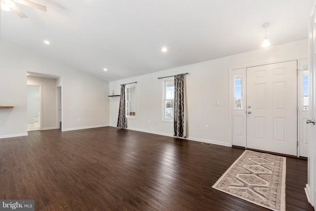 foyer featuring ceiling fan, dark wood-type flooring, and lofted ceiling