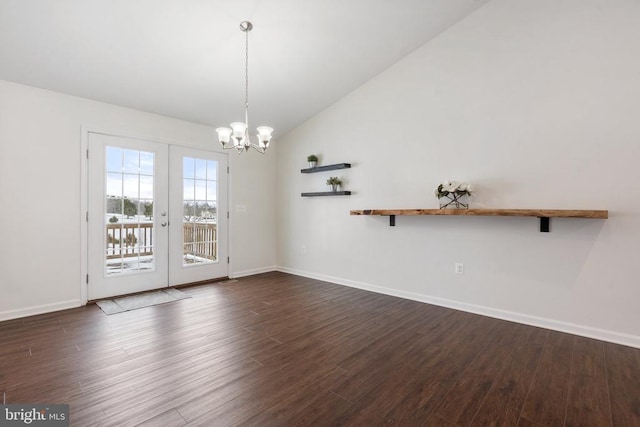 unfurnished dining area featuring a chandelier, french doors, lofted ceiling, and dark wood-type flooring