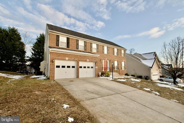 view of front facade featuring a garage and central AC