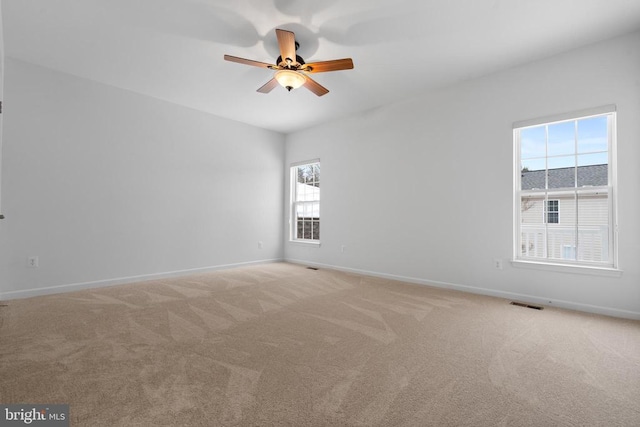 carpeted empty room with ceiling fan