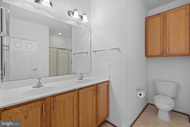 bathroom featuring toilet, an enclosed shower, and vanity