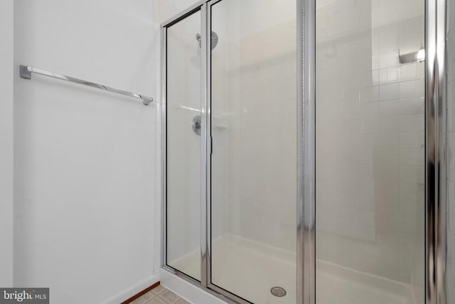 bathroom featuring a shower with door