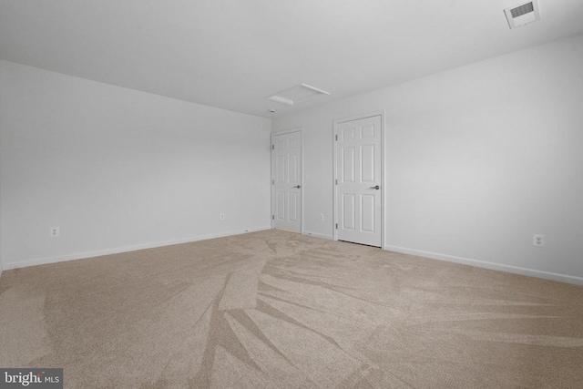 unfurnished room with light colored carpet