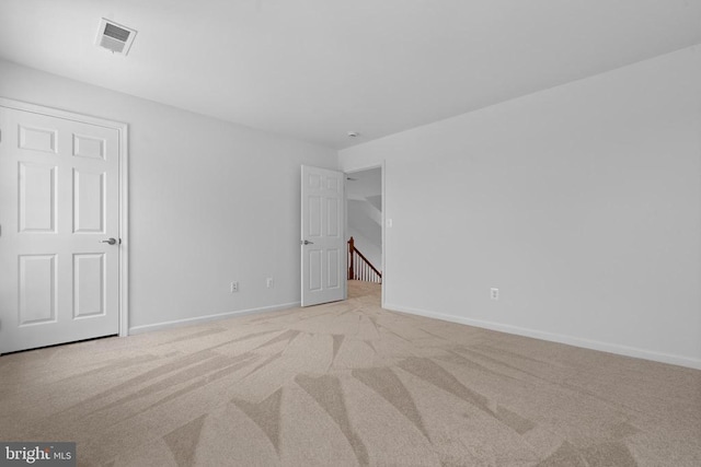 spare room with light colored carpet