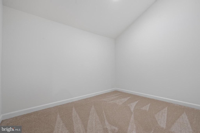 spare room with lofted ceiling and carpet floors