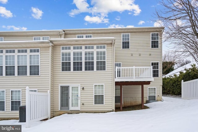 view of snow covered back of property