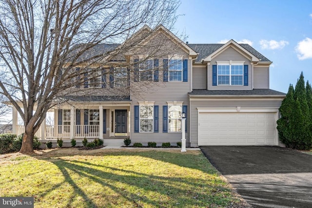 view of front facade featuring a porch, a front lawn, and a garage