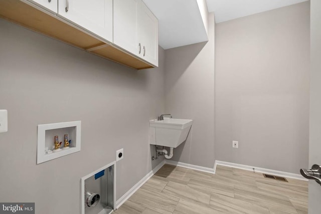 clothes washing area featuring washer hookup, cabinets, and hookup for an electric dryer