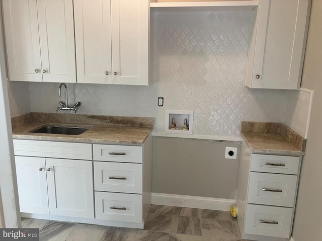 laundry area with sink, cabinets, hookup for a washing machine, and hookup for an electric dryer