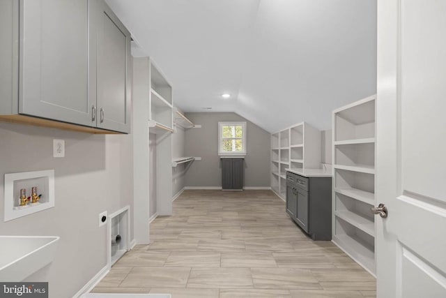 clothes washing area with washer hookup, cabinets, and hookup for an electric dryer