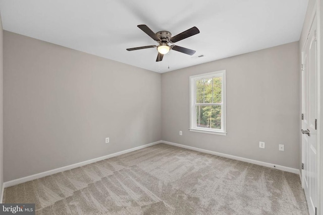 unfurnished room with ceiling fan and light colored carpet