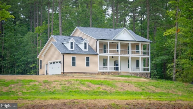 view of front of home with a porch, a balcony, a front lawn, and a garage