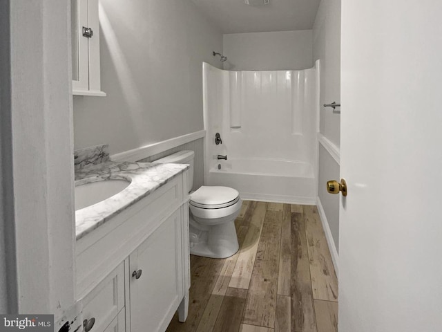 full bathroom with toilet, vanity, shower / washtub combination, and hardwood / wood-style floors