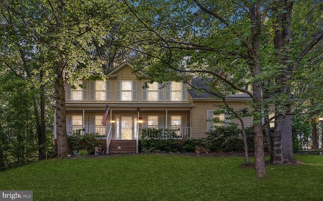 view of front of home with covered porch and a front yard