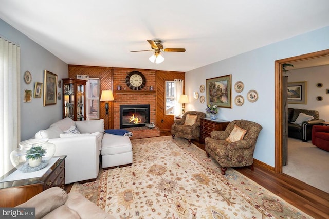 living room with a fireplace, ceiling fan, and hardwood / wood-style floors