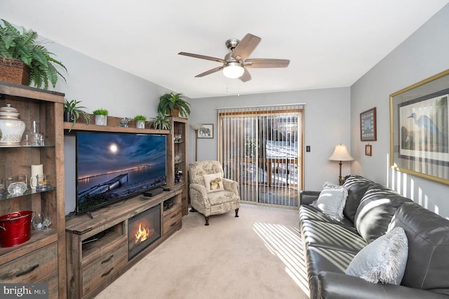 living room with light colored carpet and ceiling fan