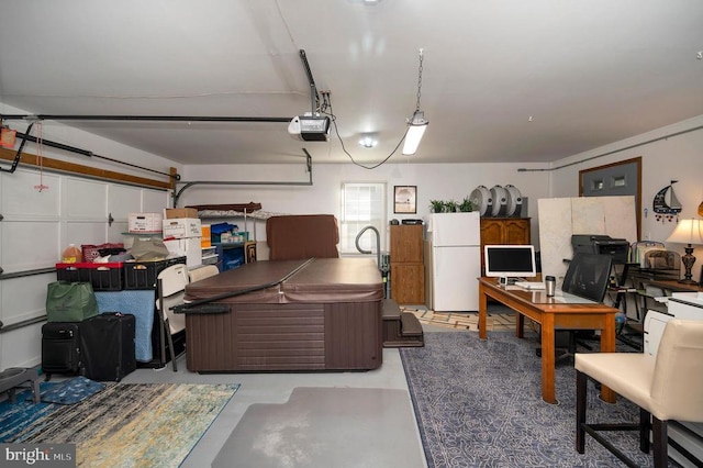 garage with a garage door opener and white refrigerator