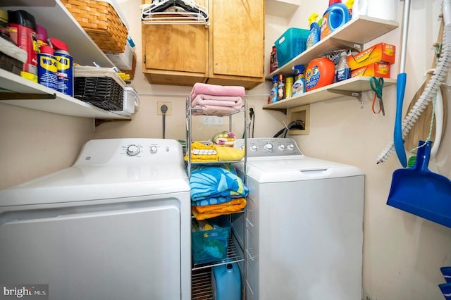 laundry area featuring cabinets and washer and clothes dryer