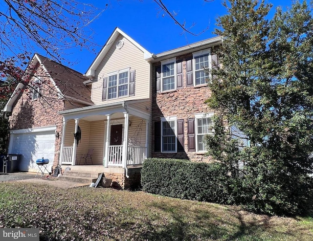 view of front of property with covered porch and a garage