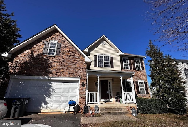 view of front of home featuring covered porch and a garage