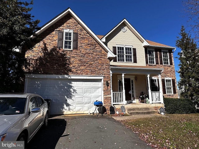 view of front of property with a porch and a garage