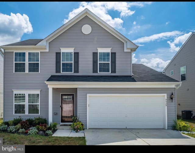 front of property featuring a garage and cooling unit