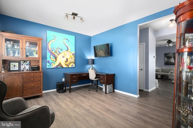 home office with track lighting, hardwood / wood-style floors, and ceiling fan