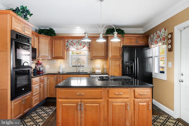 kitchen with backsplash, sink, a kitchen island, crown molding, and black appliances