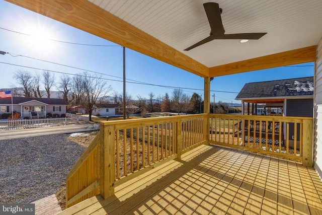 wooden terrace featuring ceiling fan