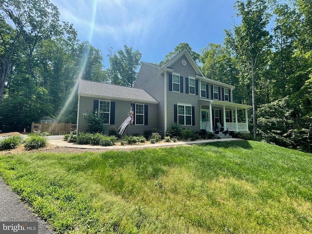 view of front of home featuring covered porch and a front yard