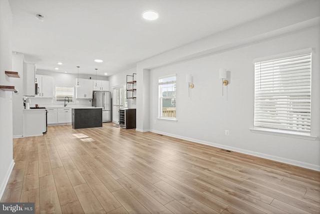 unfurnished living room featuring light hardwood / wood-style flooring