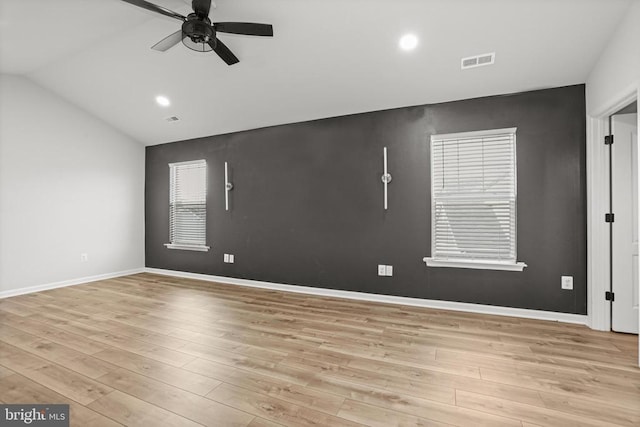 unfurnished room featuring ceiling fan, lofted ceiling, and light hardwood / wood-style floors