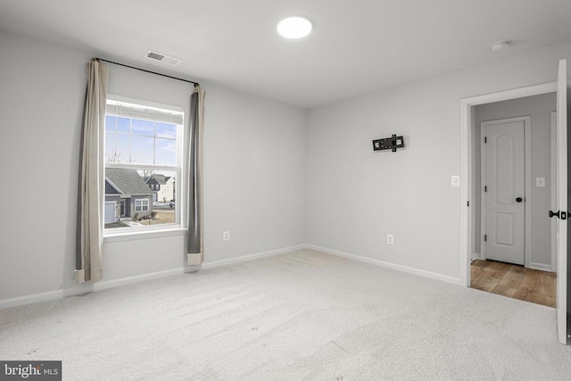 unfurnished room with light carpet