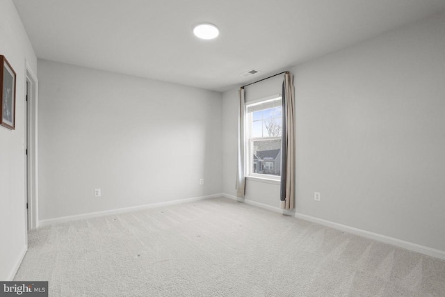 spare room with light colored carpet