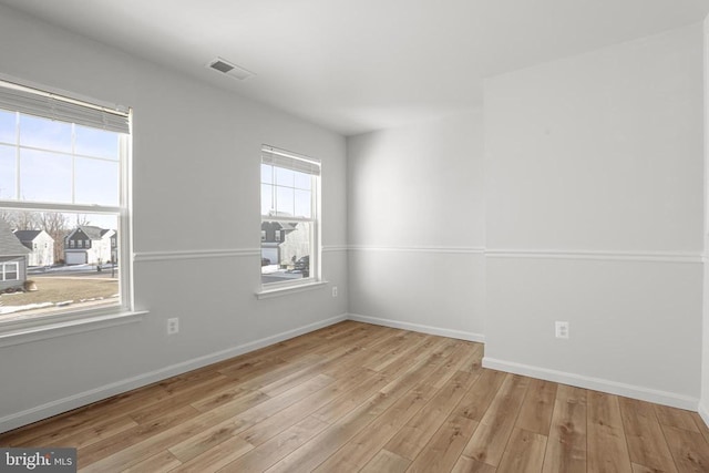 spare room with light wood-type flooring