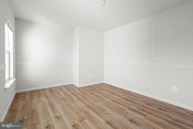 spare room featuring light wood-type flooring