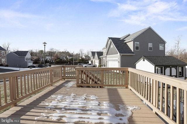 wooden terrace featuring a garage