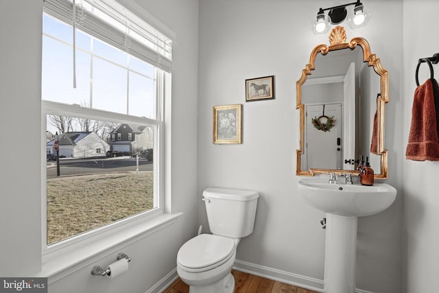 bathroom with toilet and hardwood / wood-style floors