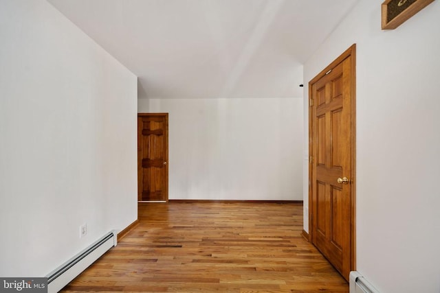 corridor featuring light hardwood / wood-style flooring and a baseboard radiator