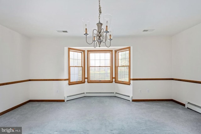 carpeted empty room featuring baseboard heating and a chandelier