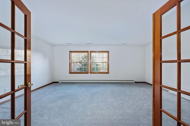 carpeted spare room featuring a baseboard radiator