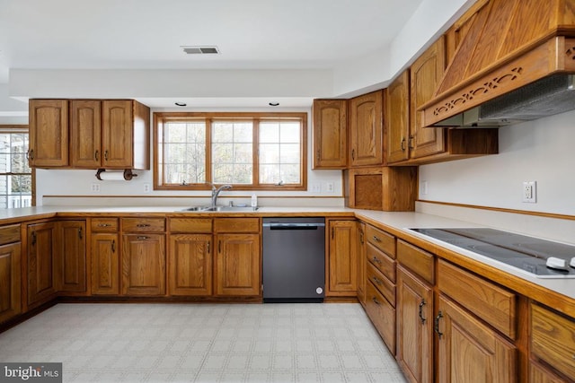 kitchen featuring sink, custom exhaust hood, and black appliances