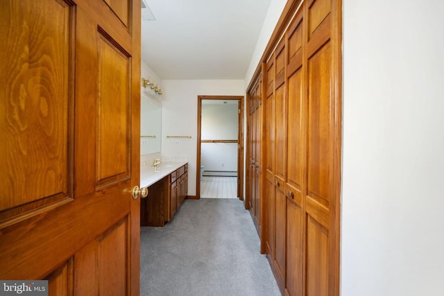 bathroom with vanity and a baseboard heating unit