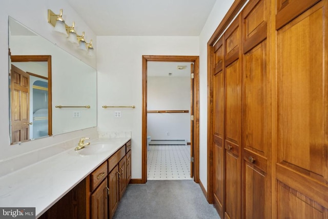 bathroom with a baseboard heating unit and vanity