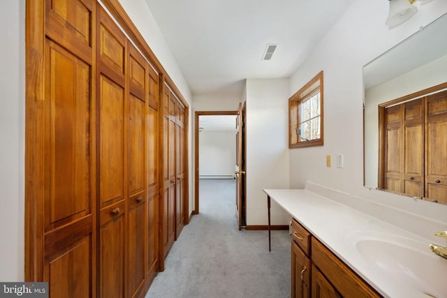 bathroom with a baseboard radiator and vanity